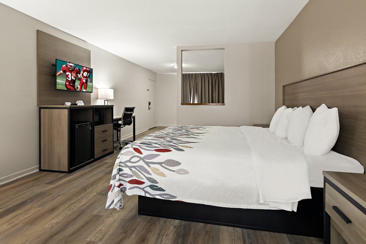 Suite King at Red Roof Inn Monroe — king bed with separate sitting area and coffee table