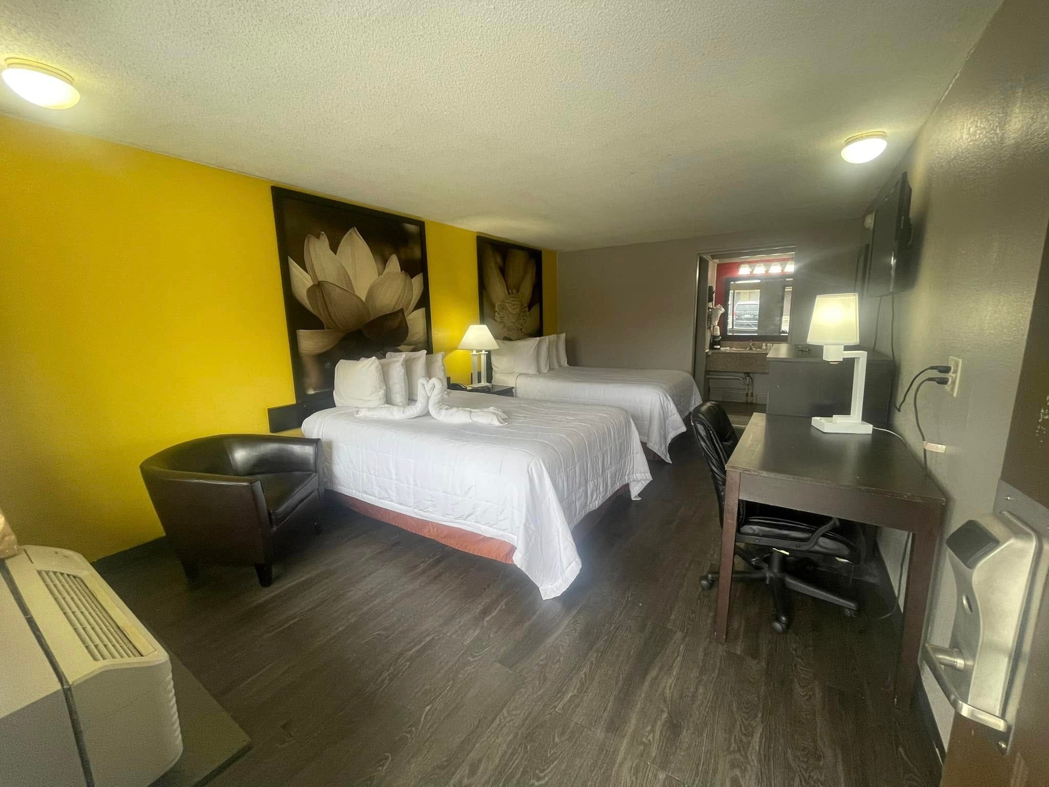 Queen room with desk, mini fridge, and TV